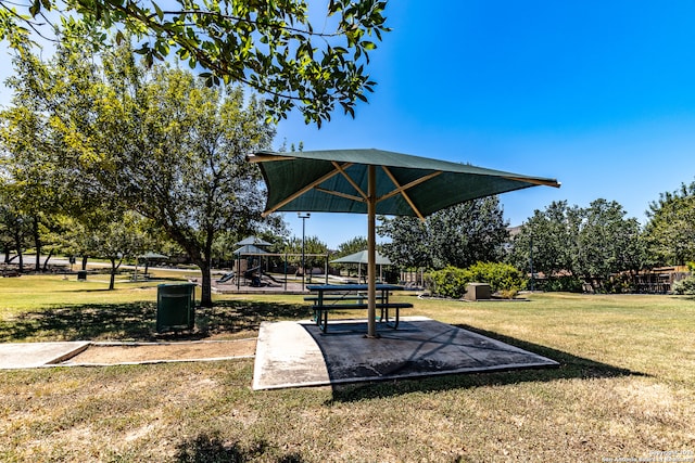 view of property's community featuring a playground and a lawn