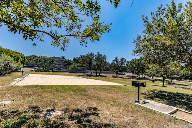 surrounding community featuring a yard and volleyball court