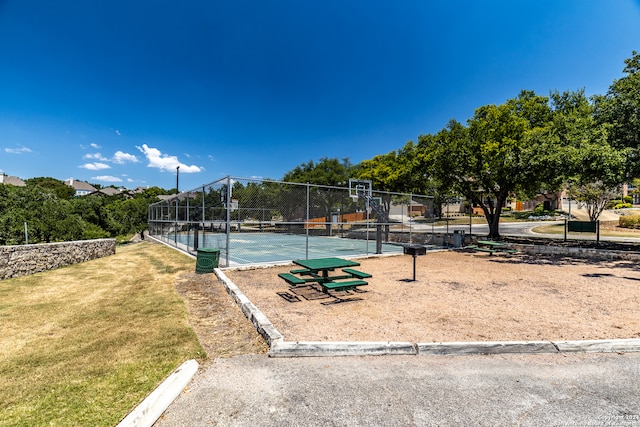 surrounding community with a yard and tennis court