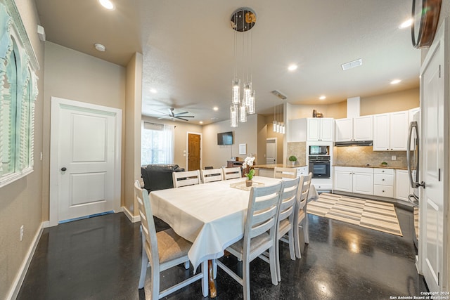 dining room featuring ceiling fan and concrete flooring