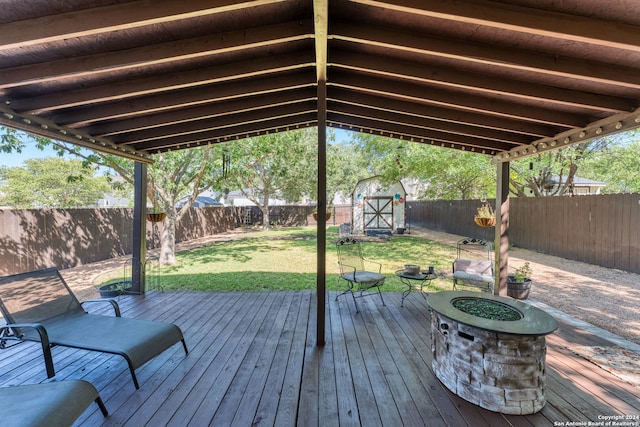 wooden deck featuring a storage shed and a yard