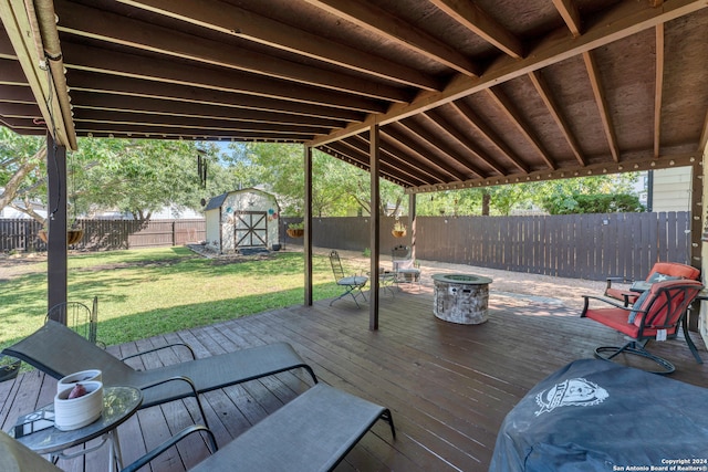 wooden deck with a storage shed and a yard