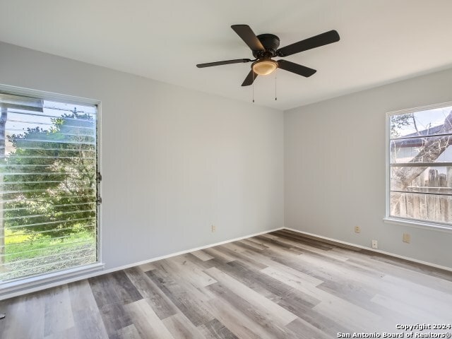 unfurnished room with hardwood / wood-style flooring and ceiling fan