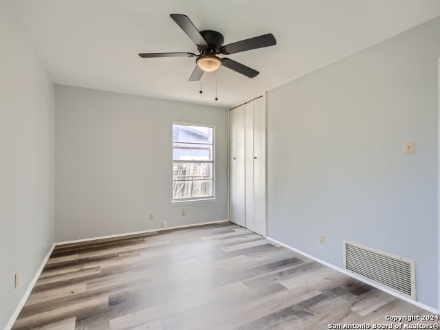 unfurnished room featuring hardwood / wood-style floors and ceiling fan