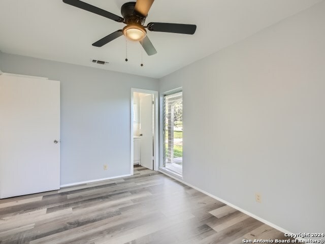 spare room with hardwood / wood-style flooring and ceiling fan