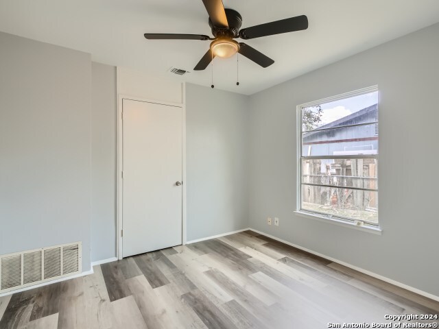 spare room with ceiling fan and light hardwood / wood-style floors