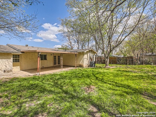 view of yard featuring a patio and central AC