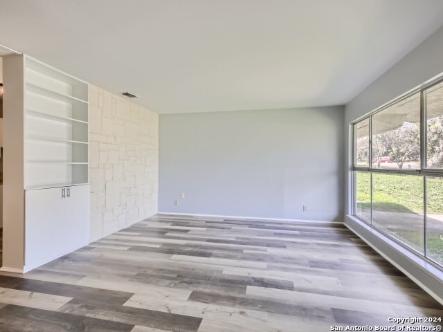 interior space with hardwood / wood-style floors and built in features