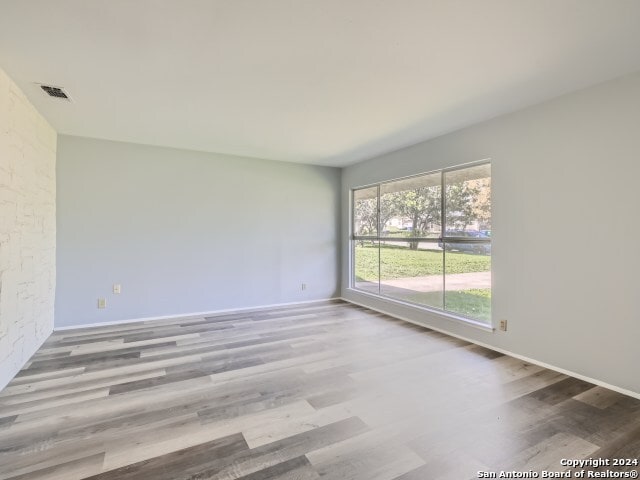 spare room with hardwood / wood-style floors