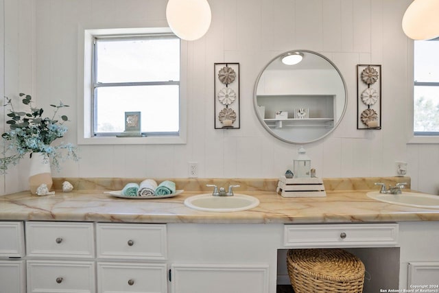 bathroom with a sink and double vanity