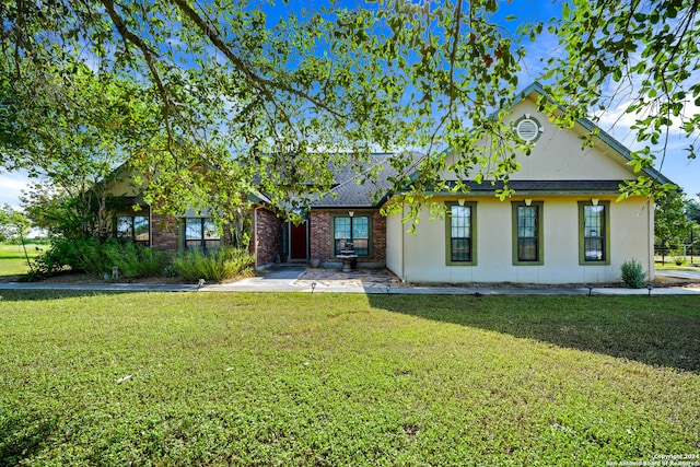 back of house with a lawn