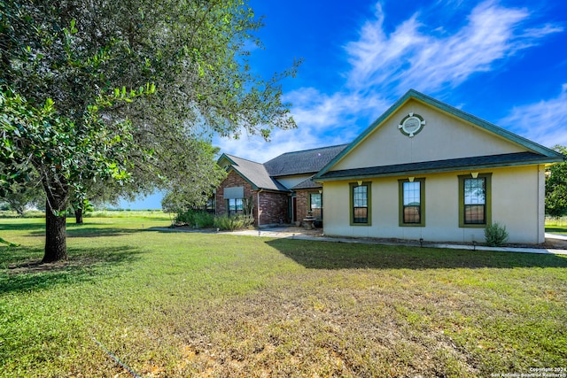 back of property with a lawn