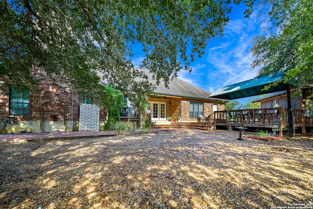 back of property with a deck and french doors