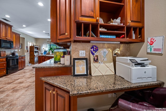 kitchen with kitchen peninsula, decorative backsplash, light tile patterned floors, and black appliances