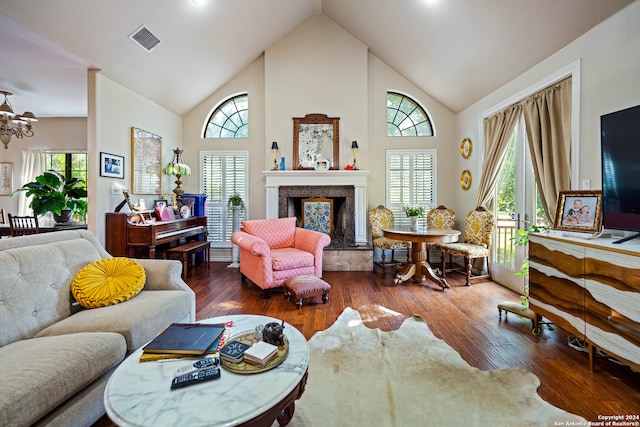 living room featuring a wealth of natural light, dark hardwood / wood-style floors, and a high end fireplace