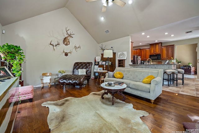 living room with sink, high vaulted ceiling, ceiling fan, and hardwood / wood-style flooring