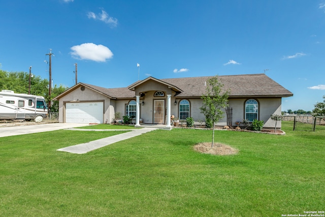 ranch-style house featuring a garage and a front yard