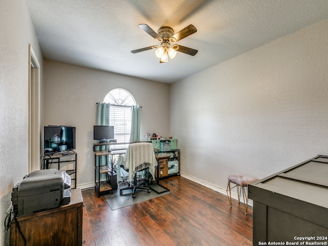 office area featuring ceiling fan, a textured ceiling, and dark hardwood / wood-style floors