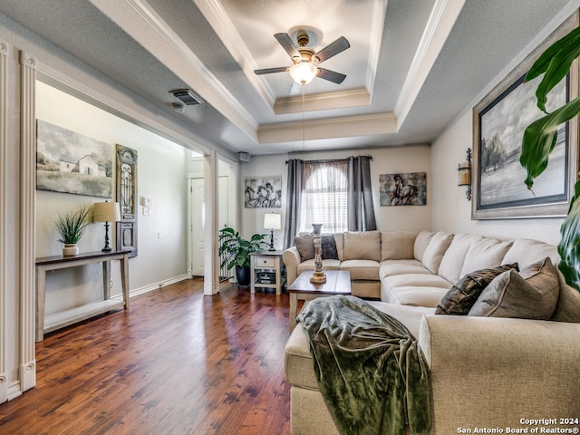 living room featuring ceiling fan, a raised ceiling, hardwood / wood-style flooring, and a textured ceiling