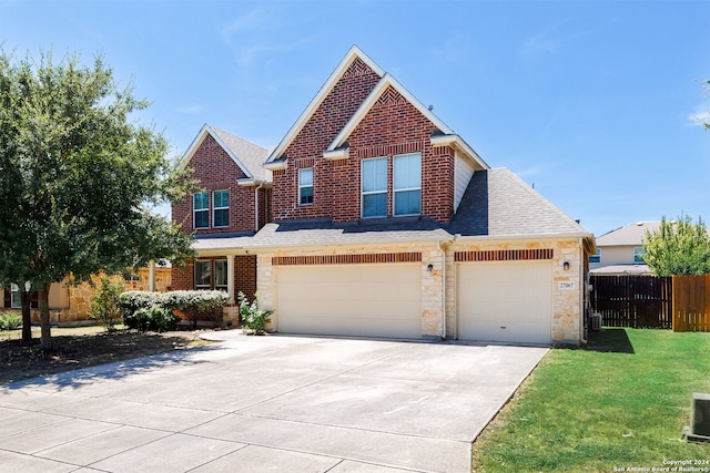 view of property featuring a garage and a front yard