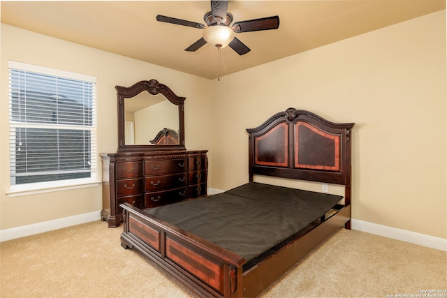 bedroom with ceiling fan and light colored carpet