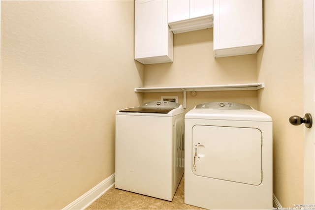 laundry area featuring cabinets, independent washer and dryer, and light tile patterned floors