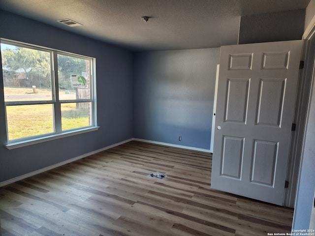 spare room with hardwood / wood-style flooring