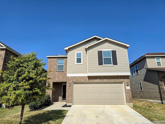 view of front of home featuring an attached garage, concrete driveway, and brick siding