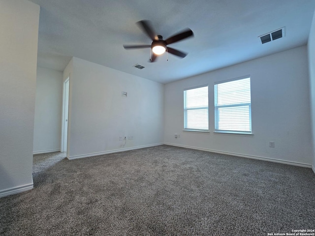 empty room featuring carpet, visible vents, and baseboards