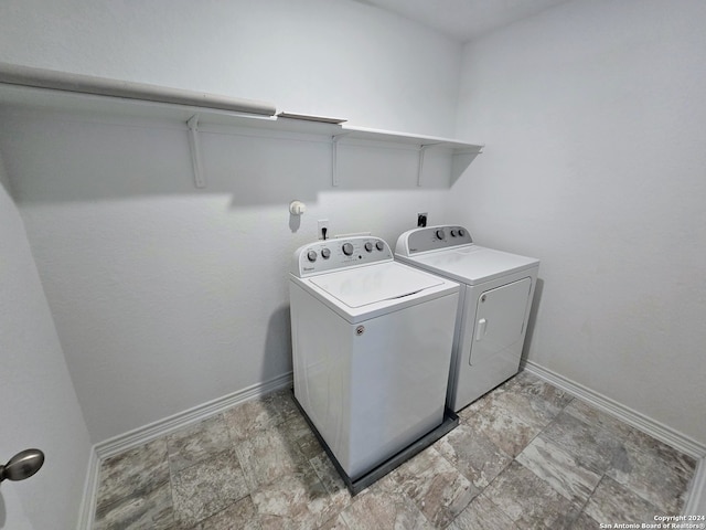 laundry area with washing machine and clothes dryer and tile patterned floors