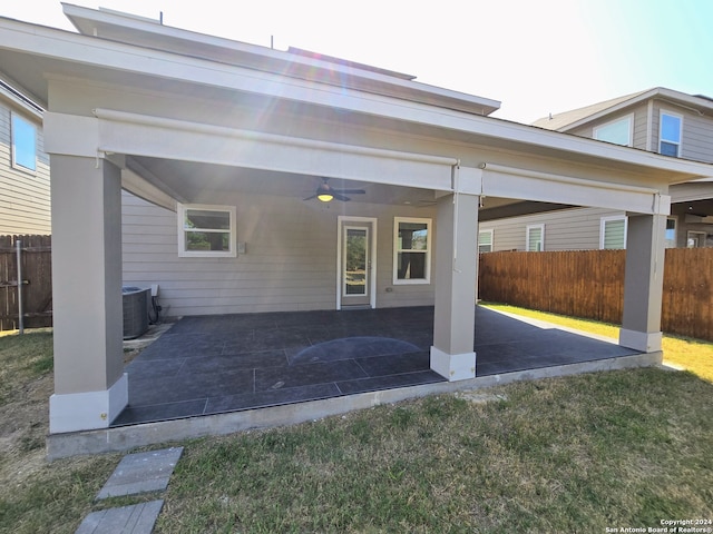 back of house with a lawn, ceiling fan, central AC unit, and a patio