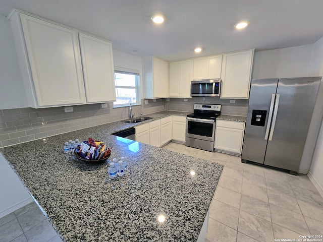 kitchen featuring light tile patterned flooring, appliances with stainless steel finishes, dark stone countertops, and tasteful backsplash