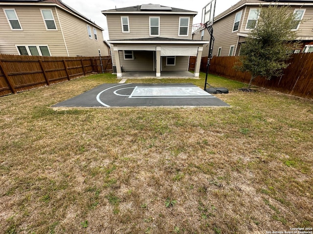 view of basketball court featuring a fenced backyard and a yard