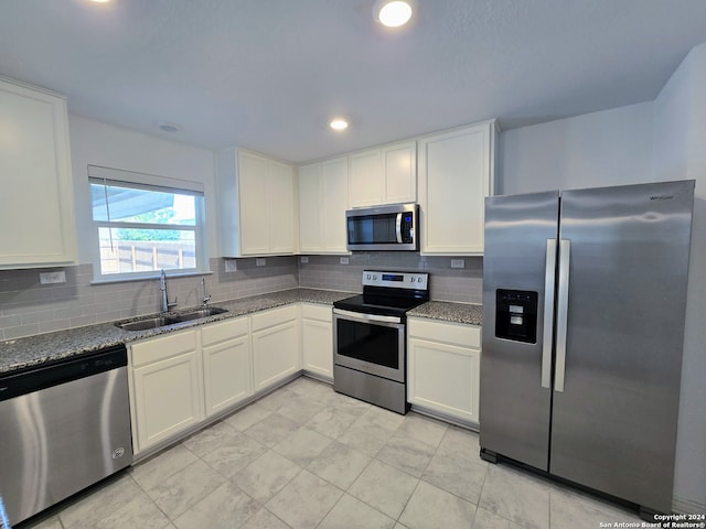 kitchen featuring sink, decorative backsplash, appliances with stainless steel finishes, and light tile patterned flooring