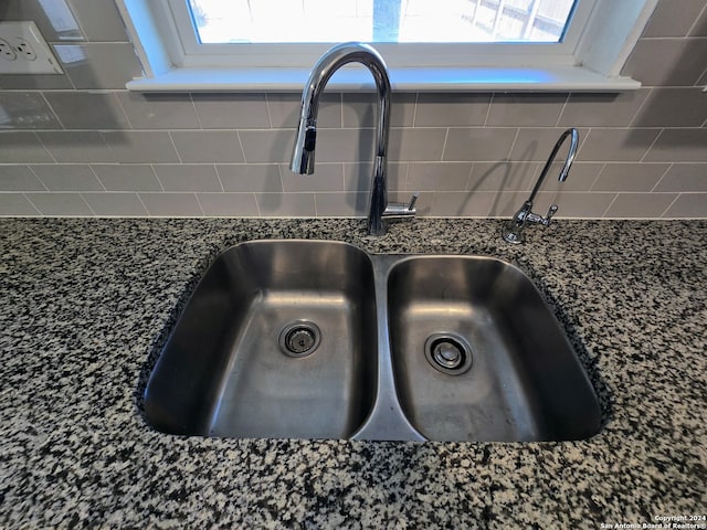 details featuring sink and dark stone counters