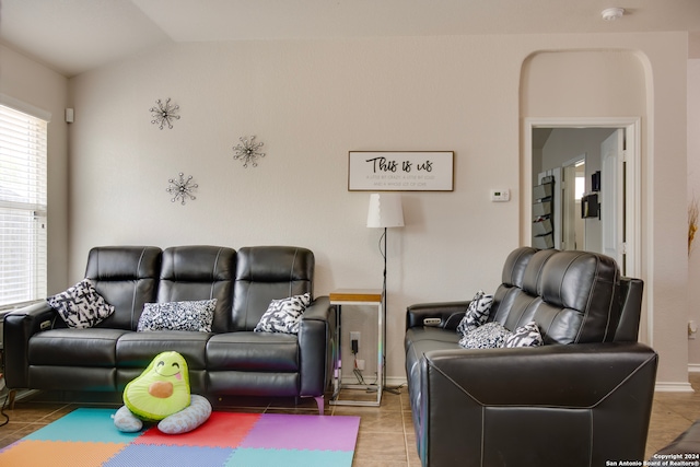 tiled living room with lofted ceiling