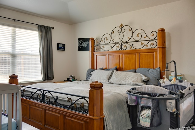 bedroom with multiple windows and vaulted ceiling