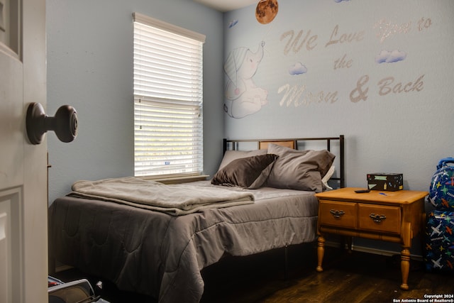 bedroom with dark hardwood / wood-style flooring