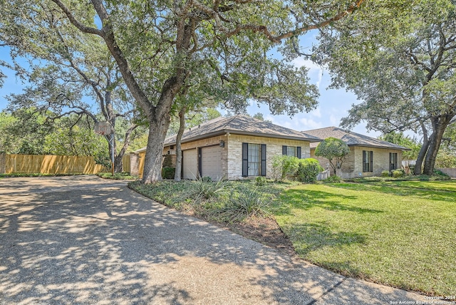 view of front of property featuring a garage and a front yard