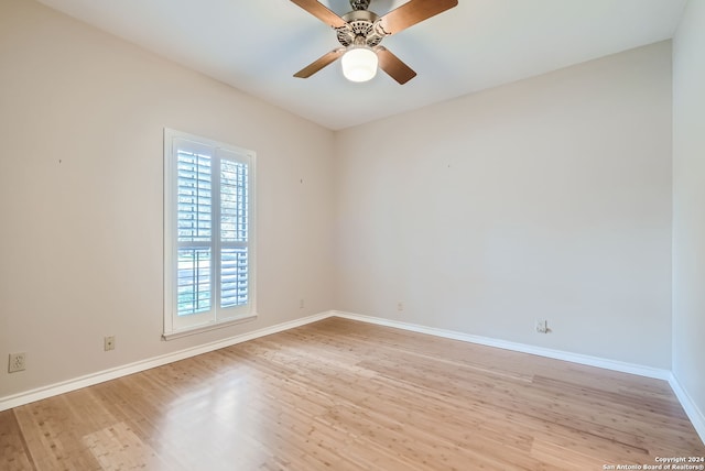 empty room featuring ceiling fan, light hardwood / wood-style flooring, and a healthy amount of sunlight