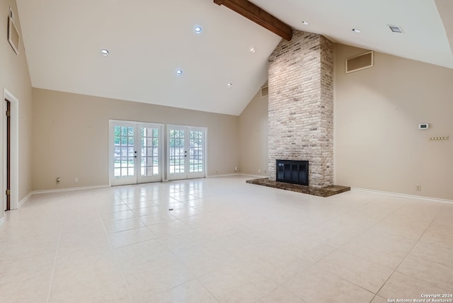 unfurnished living room with high vaulted ceiling, beamed ceiling, light tile patterned floors, and a stone fireplace