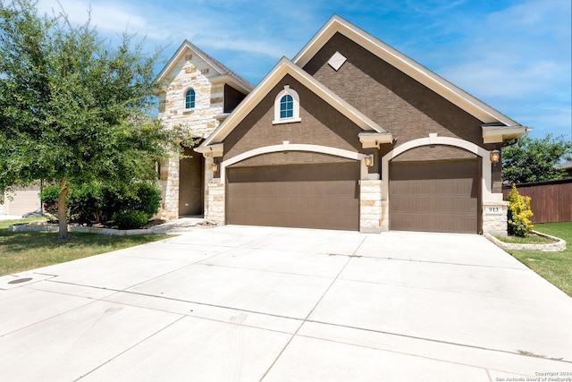 view of front facade with stone siding, concrete driveway, and an attached garage