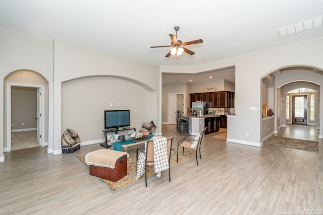 living room featuring light wood-type flooring and ceiling fan