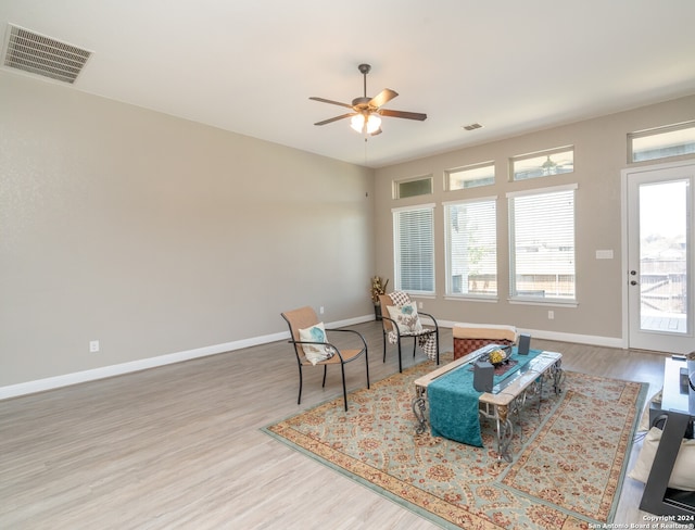 living area with ceiling fan and wood-type flooring