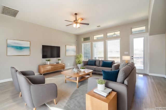 living room featuring ceiling fan and hardwood / wood-style flooring