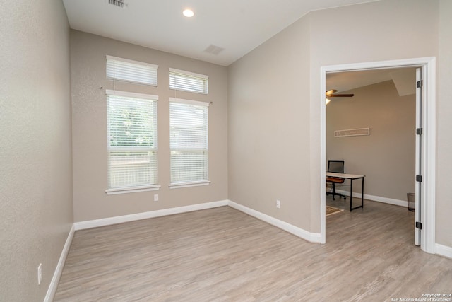 unfurnished room featuring recessed lighting, visible vents, baseboards, vaulted ceiling, and light wood-style floors