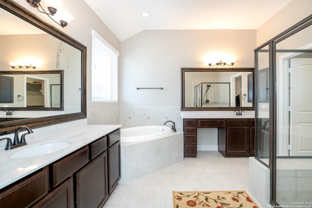 bathroom with lofted ceiling, separate shower and tub, tile patterned flooring, and vanity