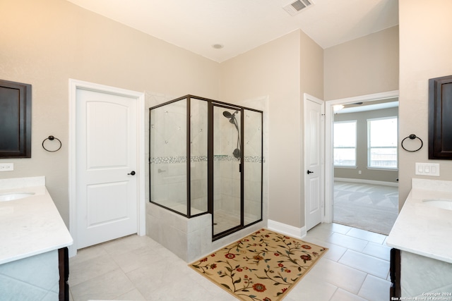 bathroom with an enclosed shower, tile patterned floors, and vanity