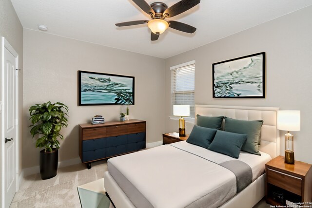 bedroom featuring ceiling fan and light carpet