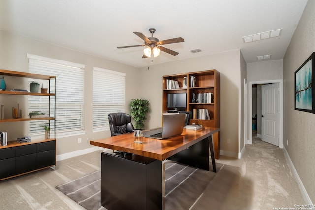 carpeted office featuring ceiling fan